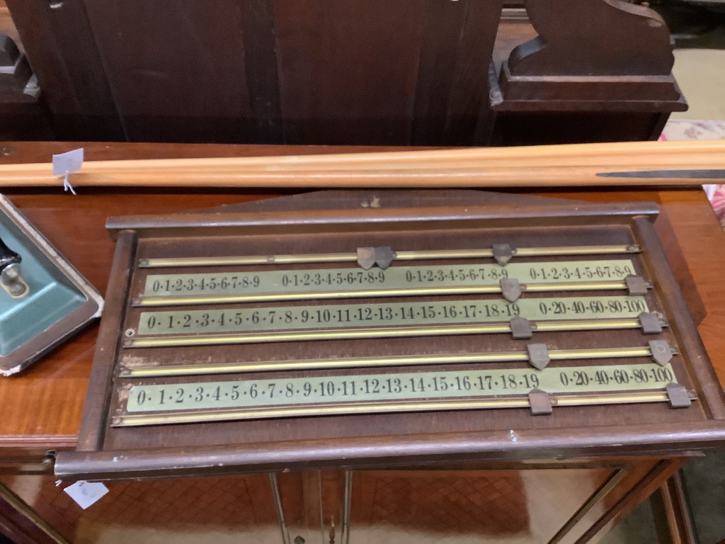 A snooker scoreboard, width 70cm, two rests, cue and a baize iron